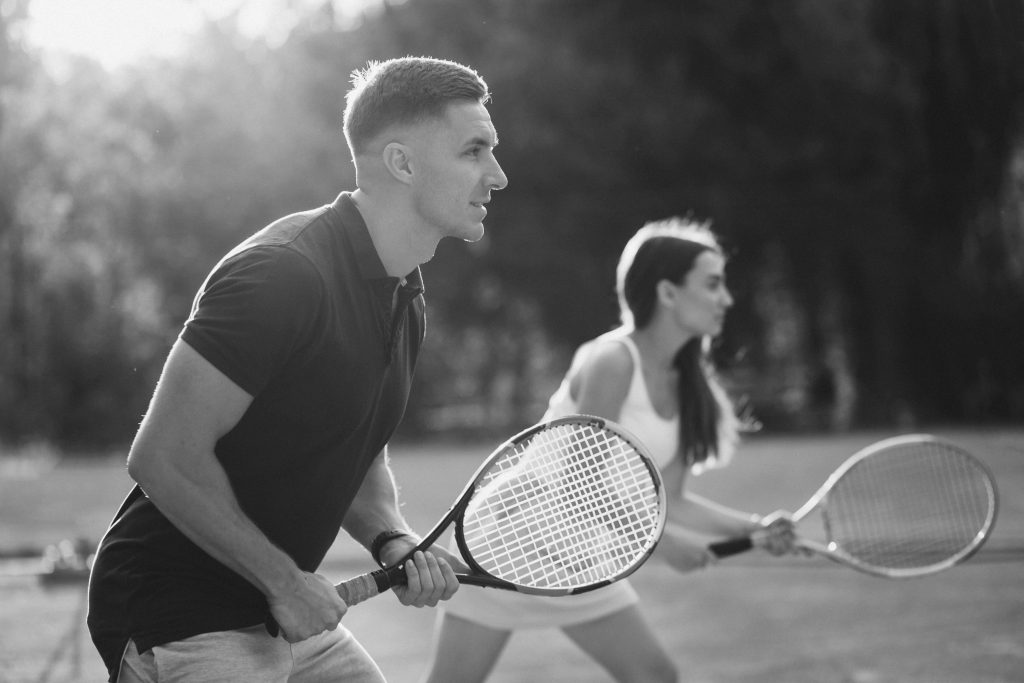 young couple playing tennis at the court young couple playing tennis at the court